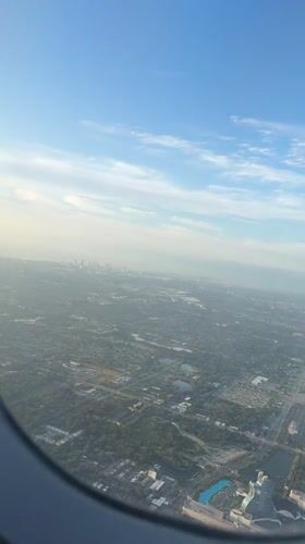 Aerial view captures Dania Beach landscape from airplane window