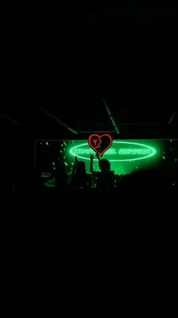 Green-lit venue with illuminated screen observed in Paris
