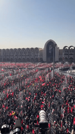 Large crowd with flags gathers at Tehran plaza