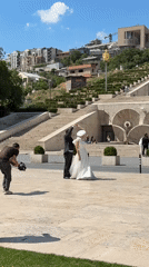 Wedding photoshoot captured at Yerevan's Cascade Complex on sunny day