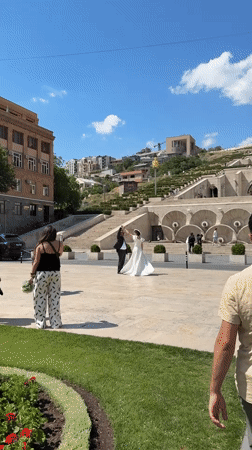 Wedding photoshoot captured at Yerevan's Cascade Complex on sunny day