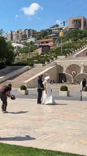 Wedding photoshoot captured at Yerevan's Cascade Complex on sunny day