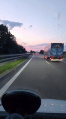 Dusk highway drive through southern Germany under a colorful sky