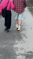 Two pedestrians walk along pathway in Saint Petersburg