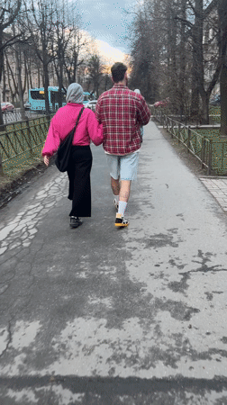 Two pedestrians walk along pathway in Saint Petersburg