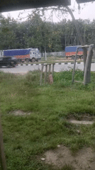 Truck traffic and a roadside stop in Daboka, India