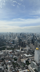 Aerial view captures Bangkok's dense skyline on overcast morning