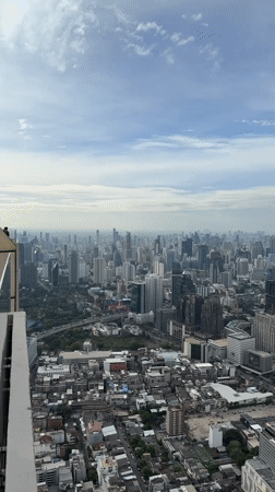 Aerial view captures Bangkok's dense skyline on overcast morning