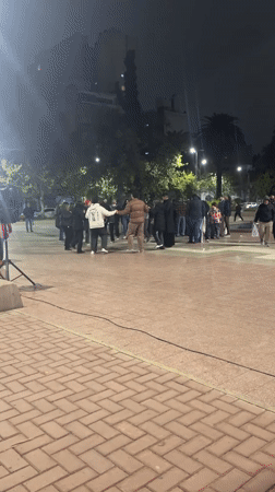 Circle dancers gather on Cordoba plaza at night