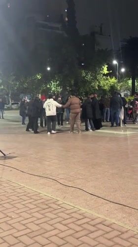 Circle dancers gather on Cordoba plaza at night