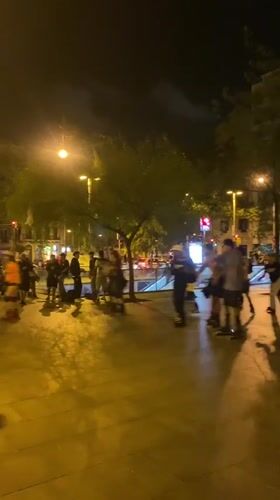Night rollerblading group gathers in illuminated Barcelona plaza