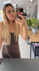 Woman takes mirror selfies at Chaikovsky salon early morning