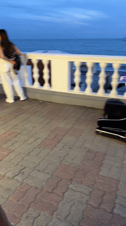 Violinist plays Sochi's Black Sea promenade at sunset