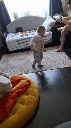 Child dances in Moscow living room with music speaker