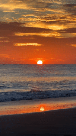 Surfboard and sunrise at Arugam Bay's shoreline
