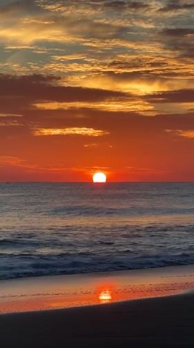 Surfboard and sunrise at Arugam Bay's shoreline