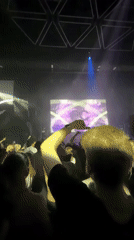 Crowd packed into Eindhoven venue under blue lights and logo screen