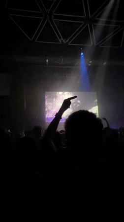 Crowd packed into Eindhoven venue under blue lights and logo screen