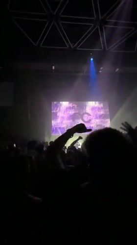 Crowd packed into Eindhoven venue under blue lights and logo screen