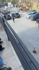 Person films parking lot from platform in Tbilisi