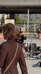 Street drummer performs under Moscow bridge for passing pedestrians
