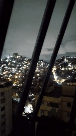 Nighttime cityscape captured across Caracas under cloudy skies