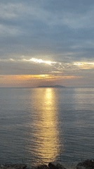 Sunrise over Nha Trang bay, clouds, geckos, and scattered trash