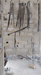Construction site shows concrete wall with electrical channels