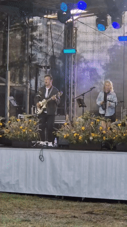 Live music and local crowds at an outdoor Priekule gathering