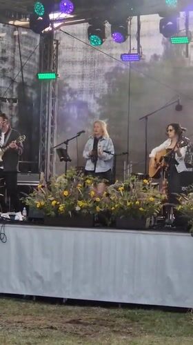 Live music and local crowds at an outdoor Priekule gathering