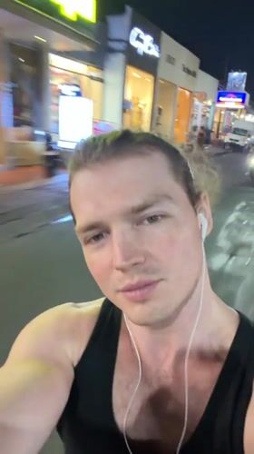 Man records himself jogging on lit street in Kuta