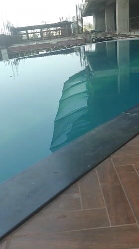 Pool reflects construction site in Kolhapur, India