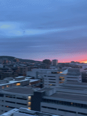 Colorful sunset observed across Montreal skyline from elevated viewpoints