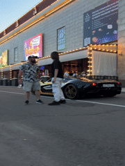 Exotic car meet outside an ornate Moscow venue at dusk