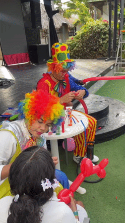 Clowns making balloons at an outdoor event in Porlamar
