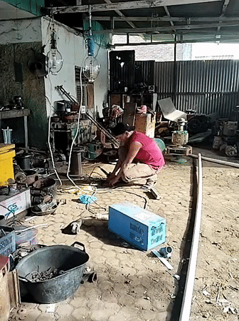 Man works with tools in Lhokseumawe garage workshop