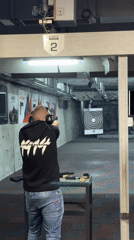 Man practices target shooting at indoor range in Bulgaria
