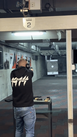Man practices target shooting at indoor range in Bulgaria