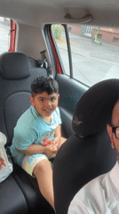 Smiling in the back seat, candy in hand, Dortmund