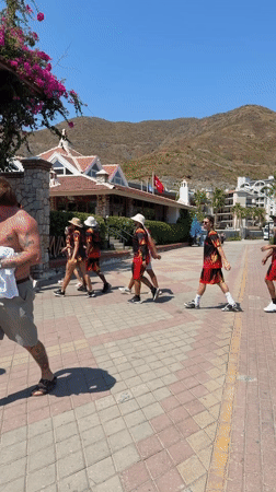 Beach, boats, and street performance on a Marmaris summer morning