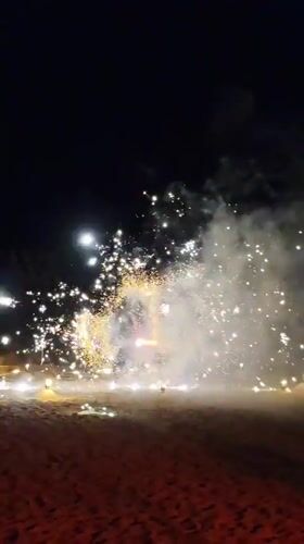 Nighttime fire performers stage pyrotechnic show on Thai beach