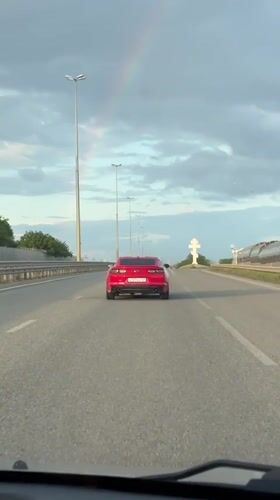 Red Camaro spotted on highway near Krasnodar during rainbow