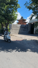 Two helmeted riders observed on white scooter in Denpasar