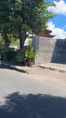 Two helmeted riders observed on white scooter in Denpasar
