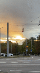 Golden dusk light over Kremenchuk streets, trolley wires overhead.