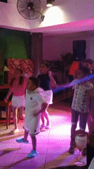 Children and women dance at Venezuela beach venue