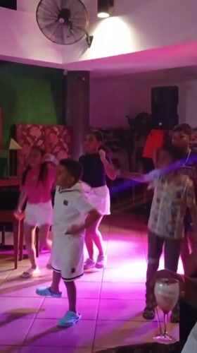 Children and women dance at Venezuela beach venue
