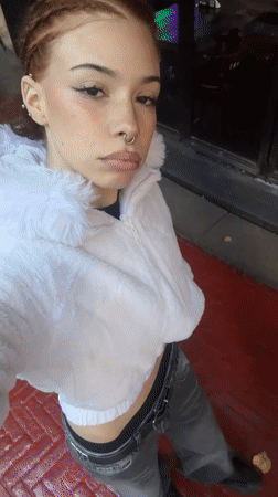Woman in white fur jacket spotted on red surface in Buenos Aires