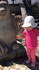 Toddler plays on animal sculptures in Wisła, Poland