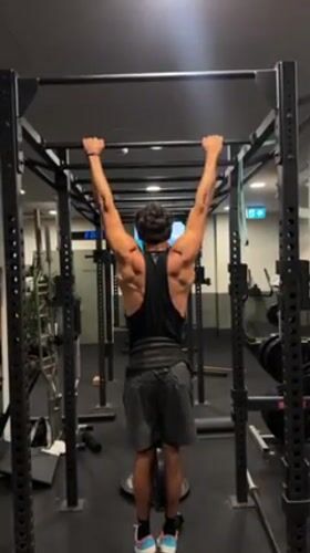 Man performs pull-ups at Bondi Beach area gym